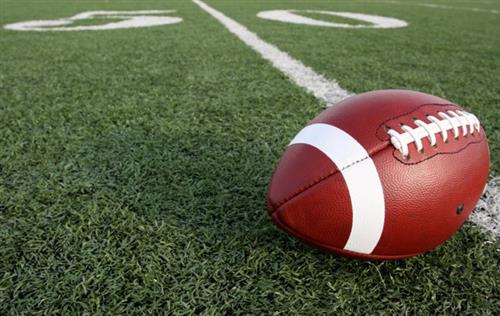 Football resting on the 50 yard line